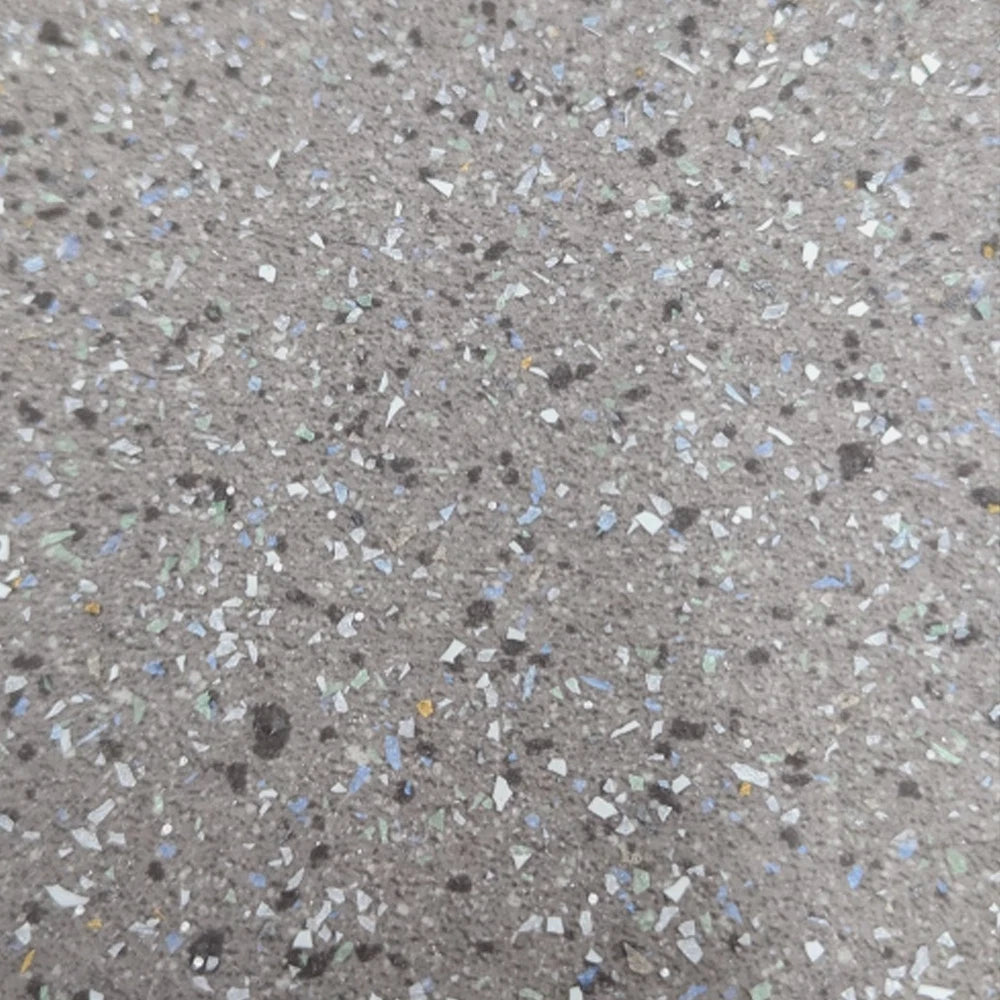 Light grey speckled vinyl flooring close-up with scattered flecks