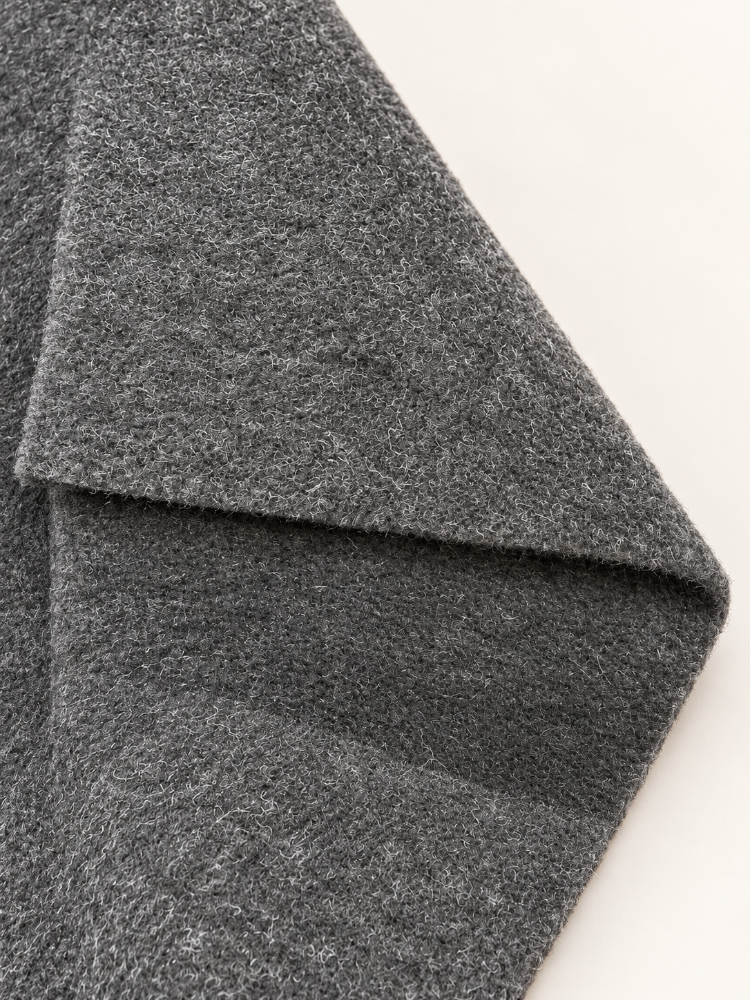 Studio-enhanced close-up of the charcoal carpet lining face and folded edge