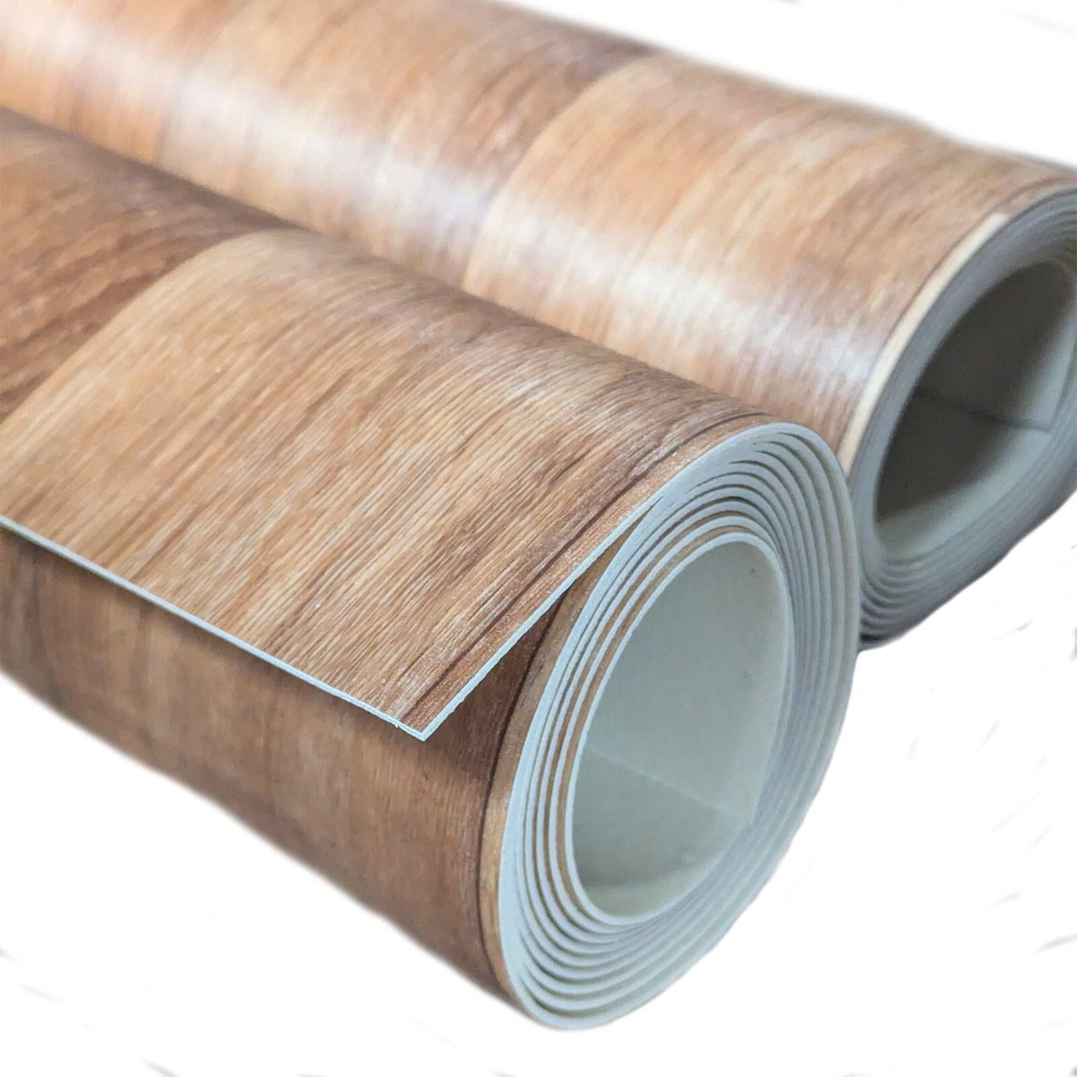 Two partly unrolled wood-effect vinyl flooring rolls showing their grey backing