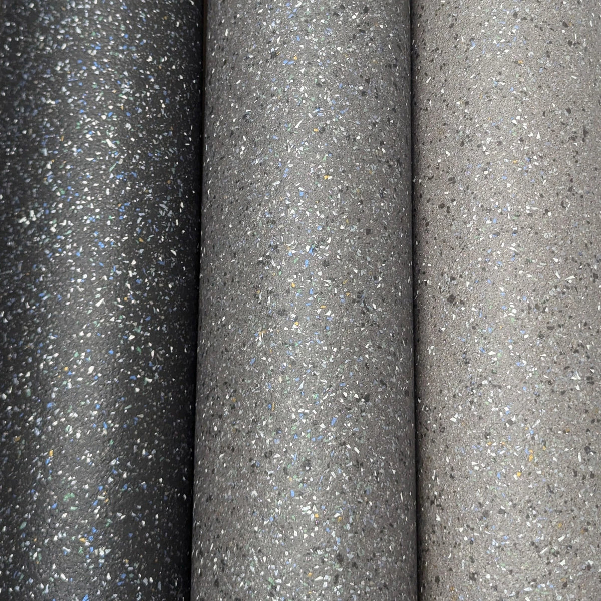 Black, dark grey and light grey speckled vinyl rolls shown side by side