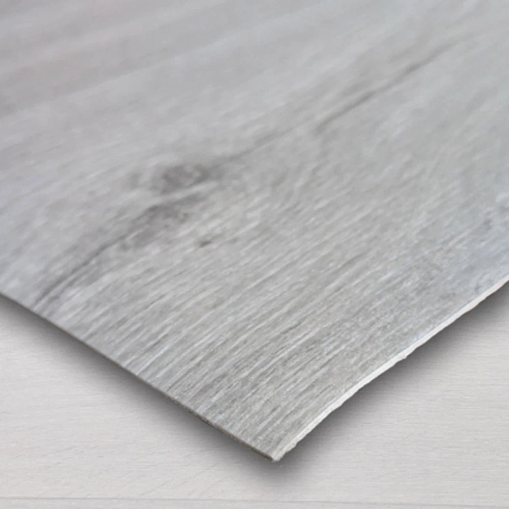 Close-up of a light grey wood-effect vinyl sheet edge and grain pattern