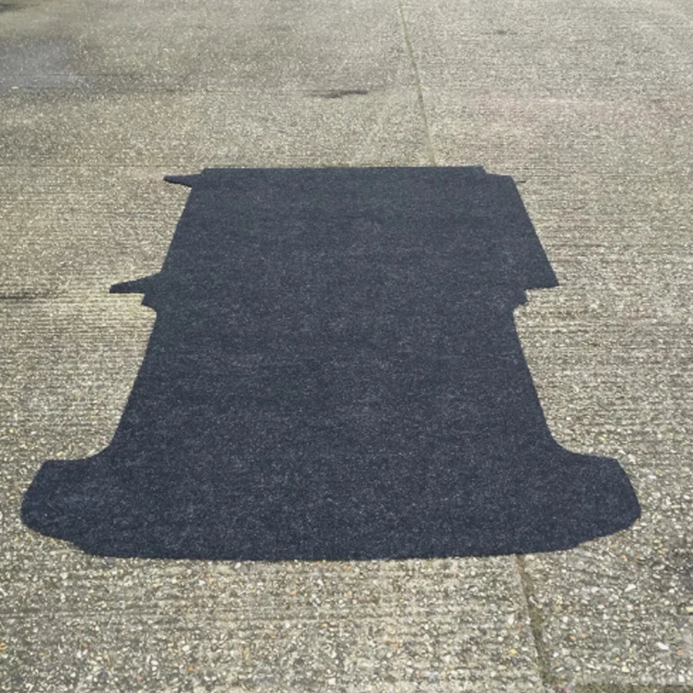 Dark pre-cut van floor laid flat, showing the shaped outline